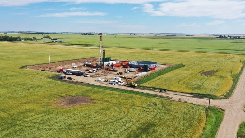 Aerial view of oilfield brine lithium extraction test site with drilling rig